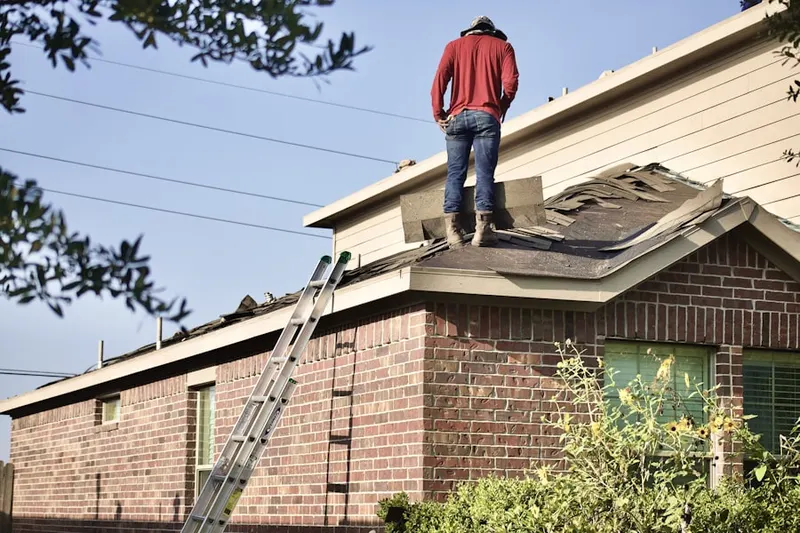 Professional roofer working on a residential roof in Darts Mills